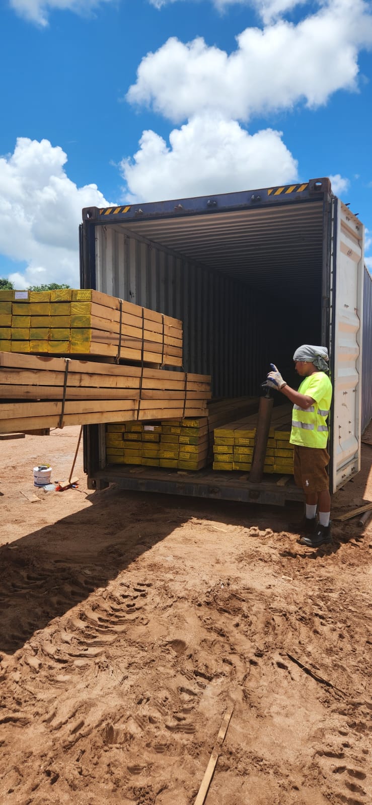 A timber bundle being loaded into a shipping container