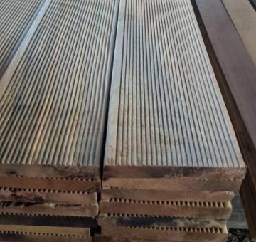 Profiled timber stacked with its grooved faces and shaped board ends visible